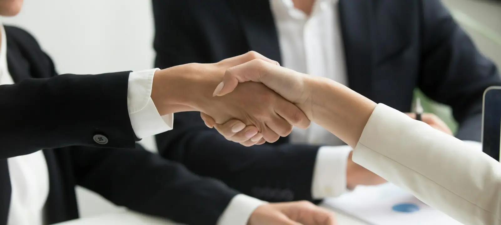 Board members shaking hands with a manager