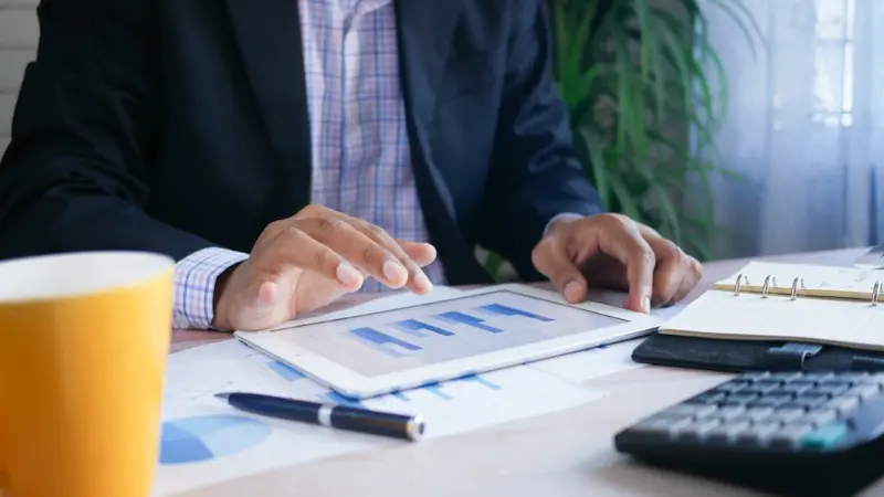 Board member reviewing financial reports on a tablet